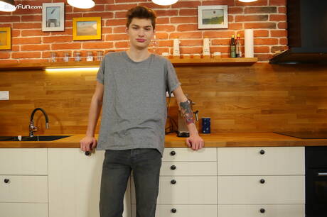 Young dude Curtis Cameron posing nude in kitchen